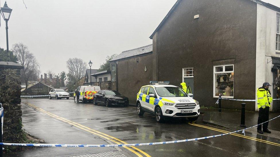 Police officers and police tape blocking a road in Llandaff, Cardiff