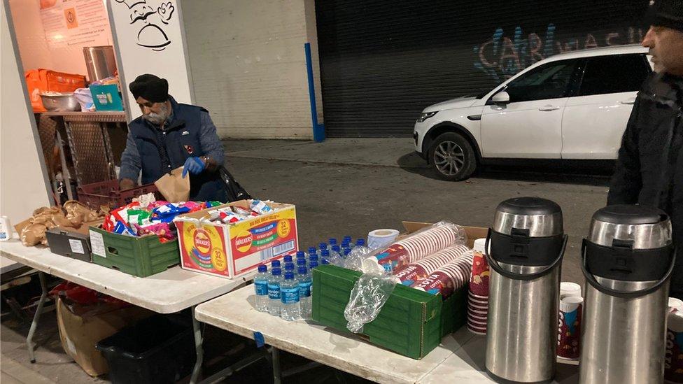 Volunteers with food and drinks on table