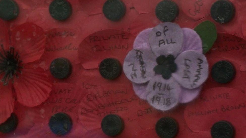 Poppies with names of serviceman and woman lost during World War One