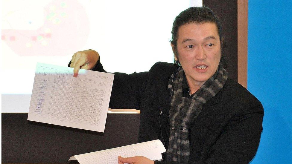 March 2014 photo of Japanese journalist Kenji Goto speaking about the Middle East at a public event in Tokyo