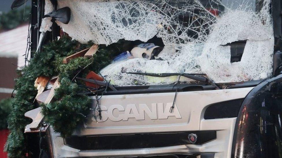 The smashed window of the cabin of a truck which ran into a crowded Christmas market Monday evening killing several people Monday evening is seen in Berlin, Germany, Tuesday, Dec. 20, 2016.