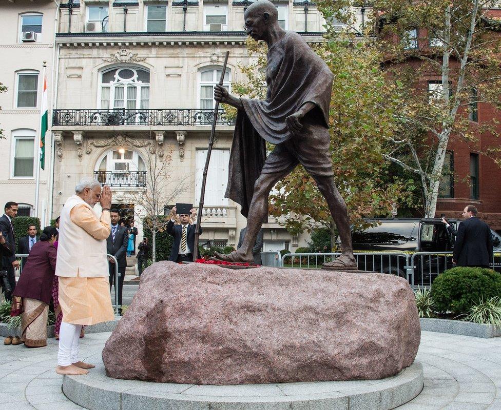 Indian Prime Minister Narendra Modi pays his respects at a statue of Mahatma Gandhi in front of the Indian embassy in Washington on September 30, 2014.