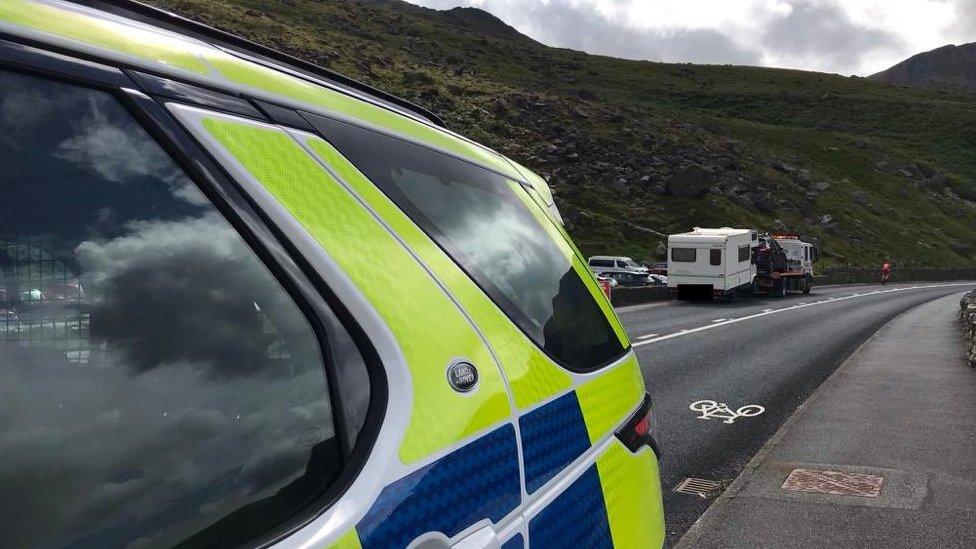 Caravan on a tow truck and police car