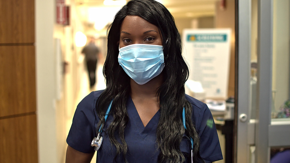 a nurse wears a mask