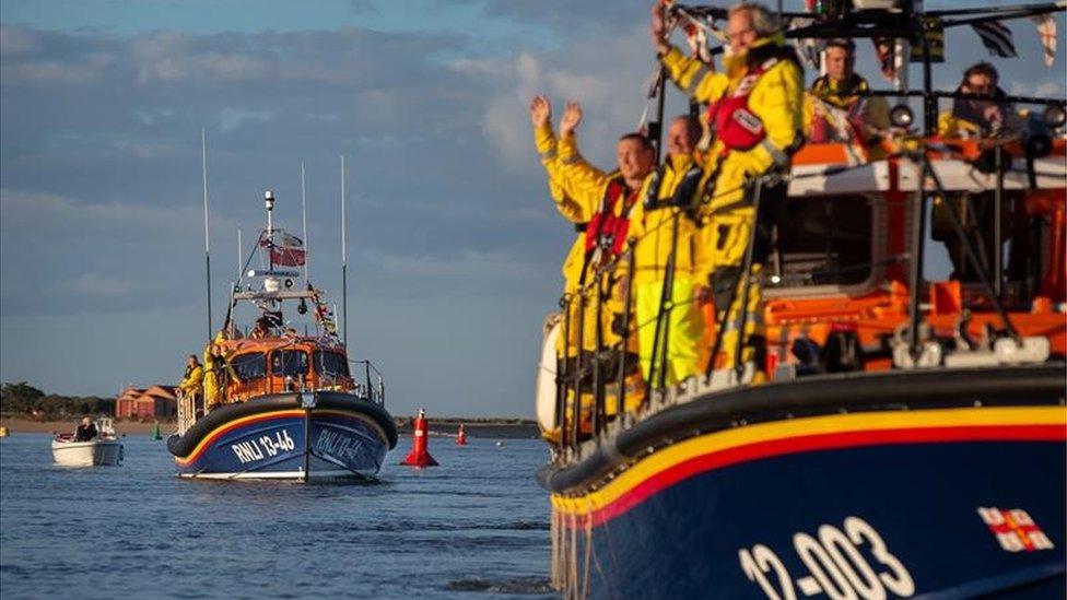 RNLI crew wave to onlookers from on board lifeboats the Doris Mann of Ampthill and the Duke of Edinburgh