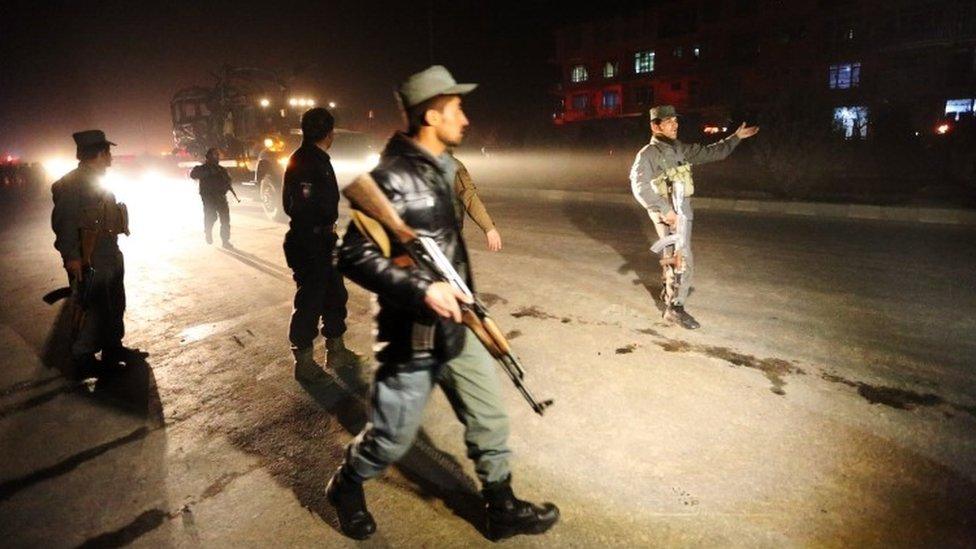 Afghan security forces inspect the site of a suicide attack in Kabul (20 January 2016)