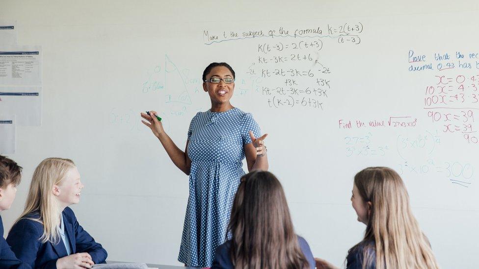 A teacher standing in front