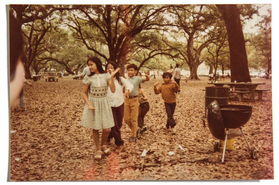 Vira's sister Sundary, her brother Nadirak, and other Khmer children dance at a barbecue in New Orleans