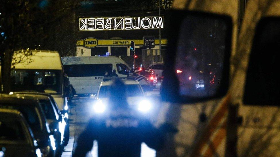 Police officers are pictured as police conduct new searches linked to the November 13 Paris terrorist attacks, on December 30, 2015, in Molenbeek, Brussels.