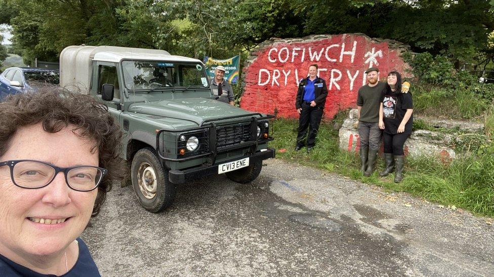 Elin Jones and other volunteers at the Cofiwch Dryweryn mural after it was restored