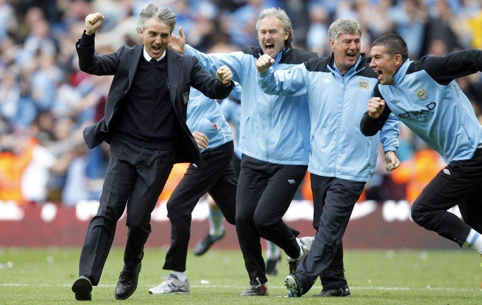 Roberto Mancini and his coaching staff celebrate Sergio Aguero's title-winning goal