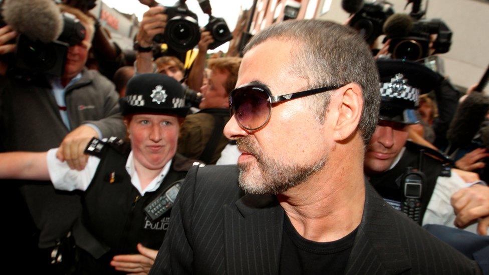 British singer George Michael is escorted out of Highbury Corner Magistrates Court in London, August 24, 2010