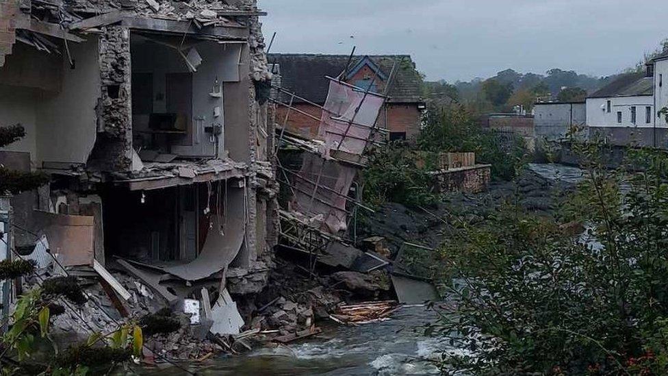 The damage to the rear of the building next to the river