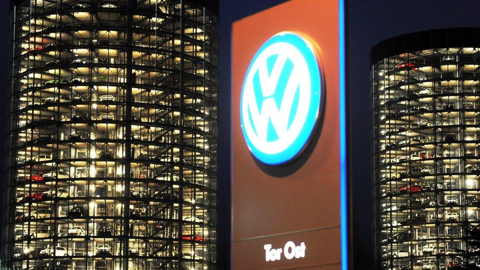 VW logo in front of the storage towers of the company's Autostadt in Wolfsburg