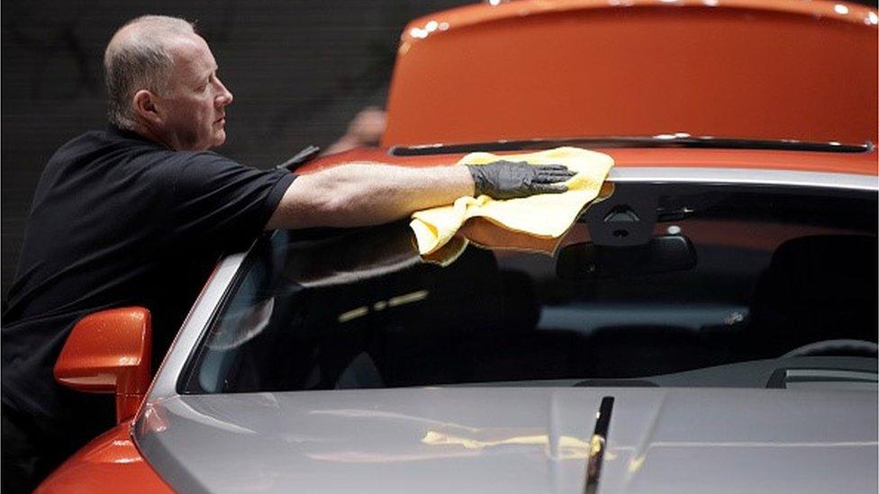 Rolls-Royce with worker polishing