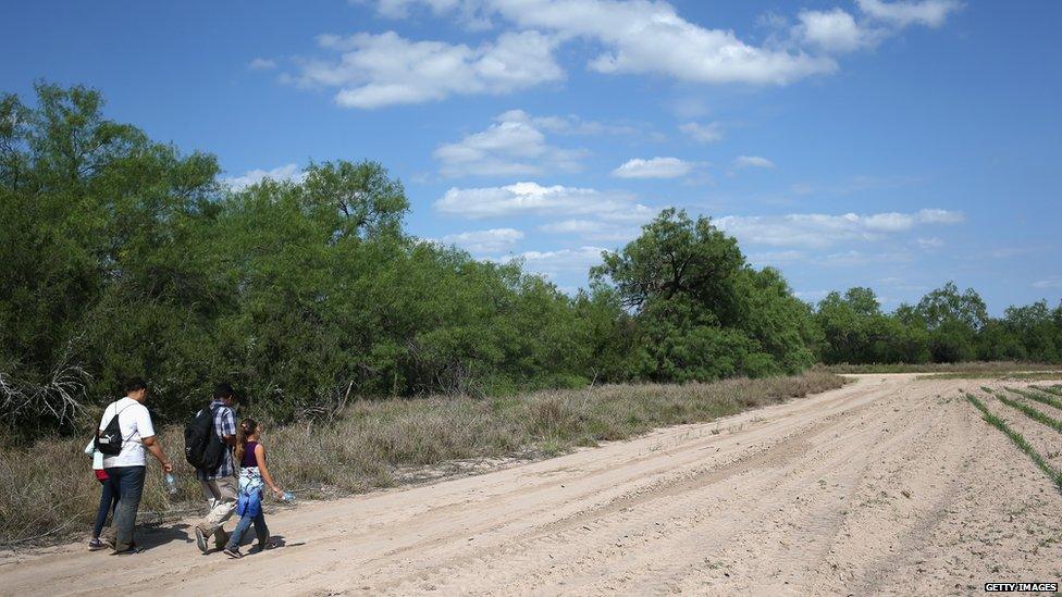 Migrants attempt to cross the US-Mexico border