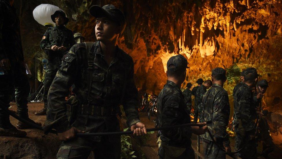 Soldiers relaying electric cables into the cave system