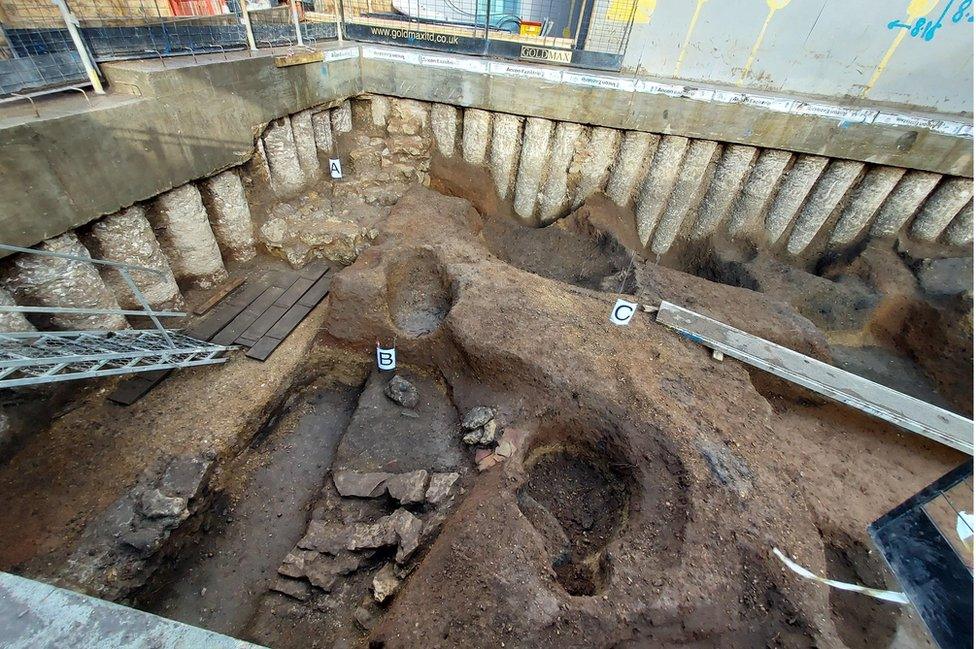 The remains of the possible Bronze Age barrow mound (C), on top of the original prehistoric ground surface (B), cut by the foundations to St Mary's College