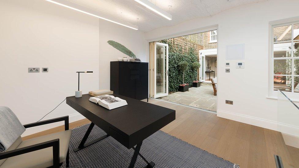 The interior of a modern minimalist courtyard garden office