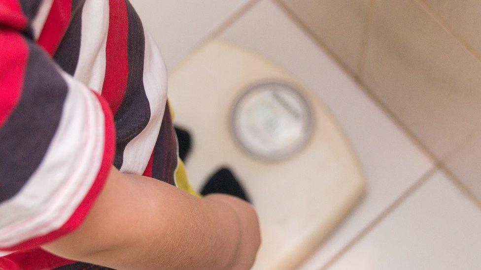 Child on weighing scales