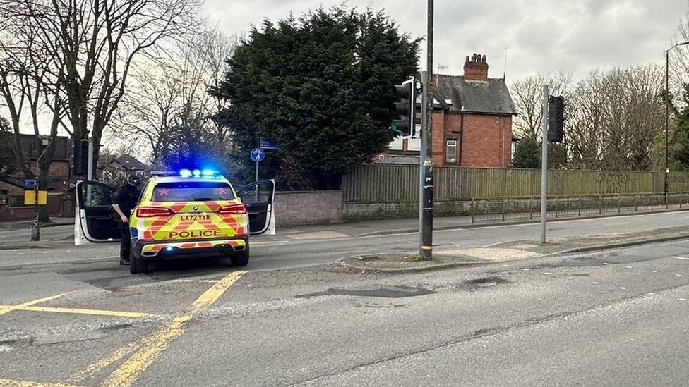 A police car on Edge Lane in Stretford