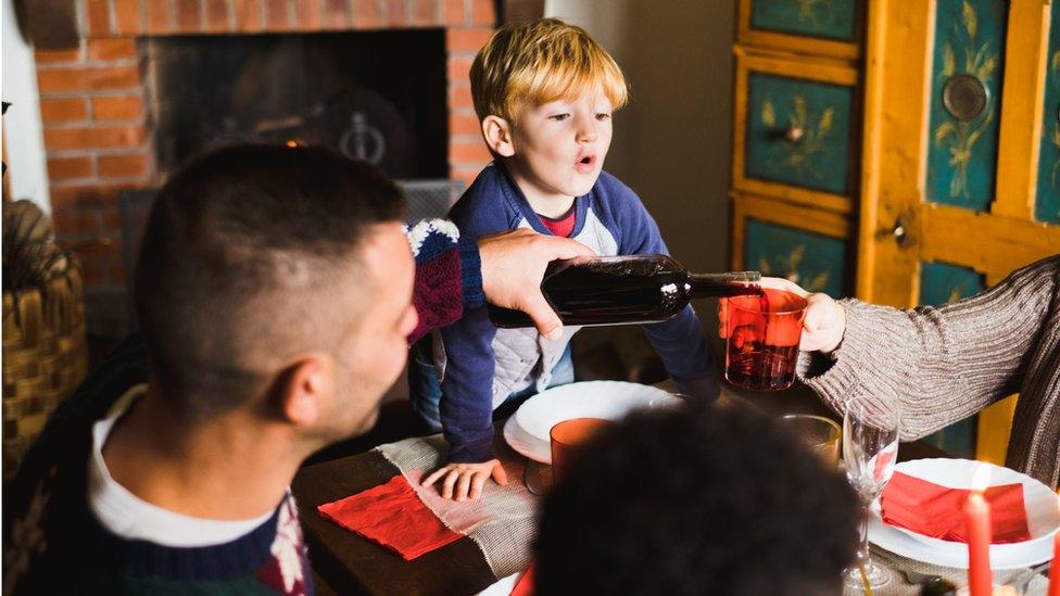 Filling glasses at the Christmas table