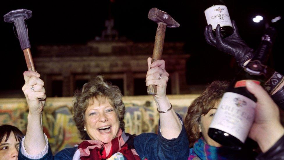 Berliners celebrate the collapse of the Berlin Wall in November 1989