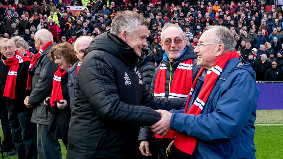 Ole Gunnar Solskjaer greets older mascots