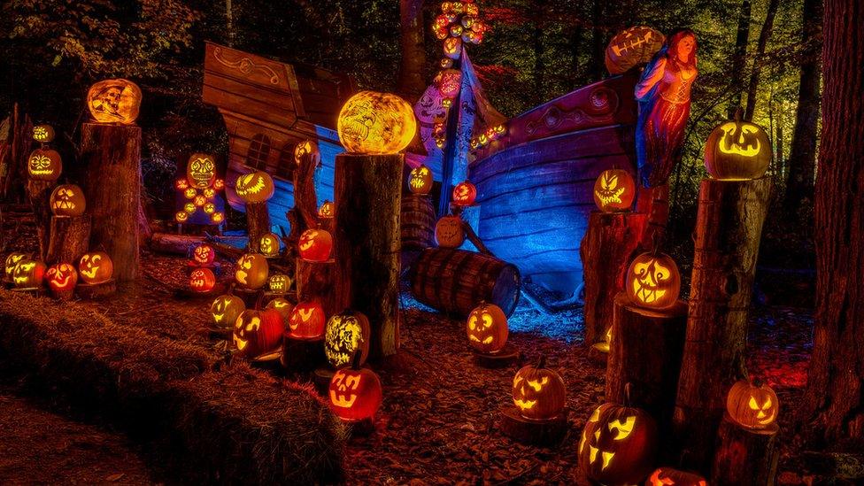 A pirate ship covered with lots of different pumpkins.