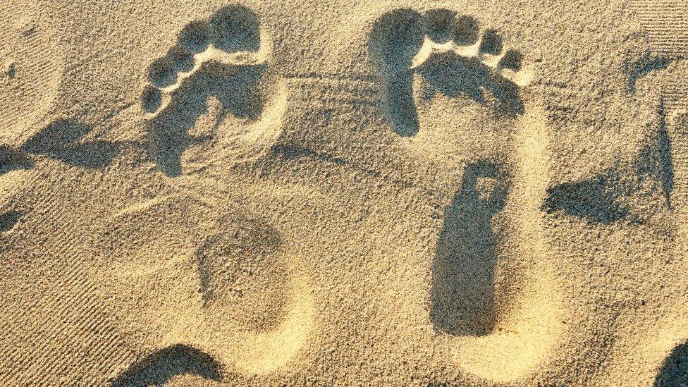 Bare foot sand prints.