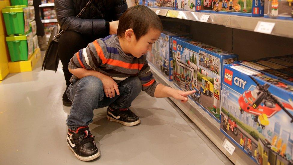 Boy choosing LEGO in a shop in Beijing