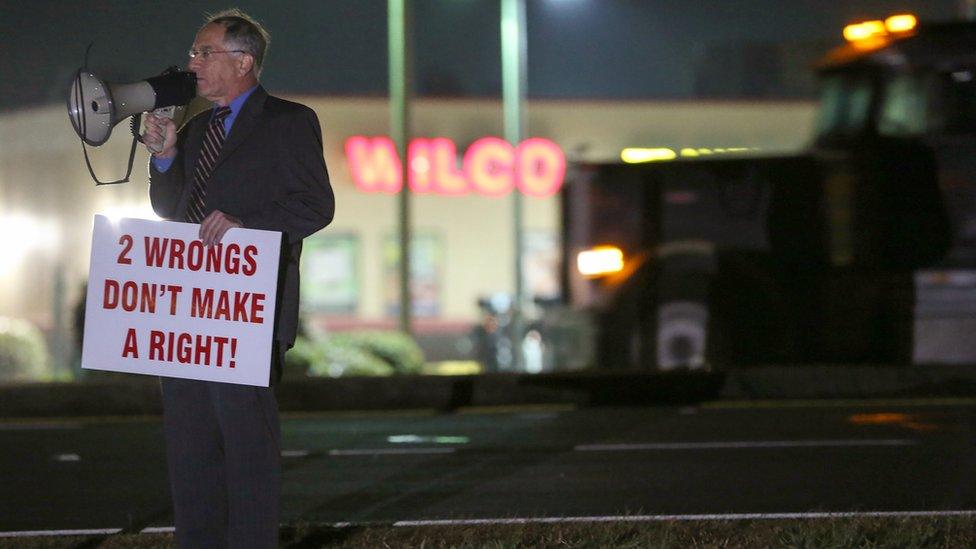 Attorney Daniel Kolber uses a megaphone to voice his opposition to the death penalty while standing just outside the Georgia Diagnostic and Classification State Prison grounds in Jackson, Ga., Tuesday, Feb. 2, 2016.