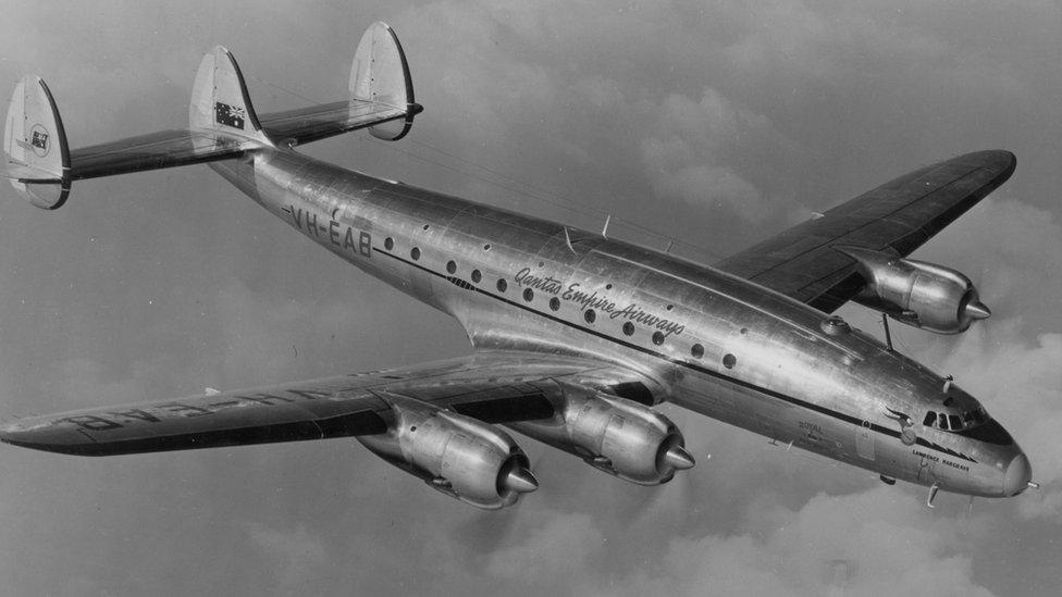 A black-and-white photo of a Lockheed Constellation marked "VH-EAB Qantas Empire Airways"