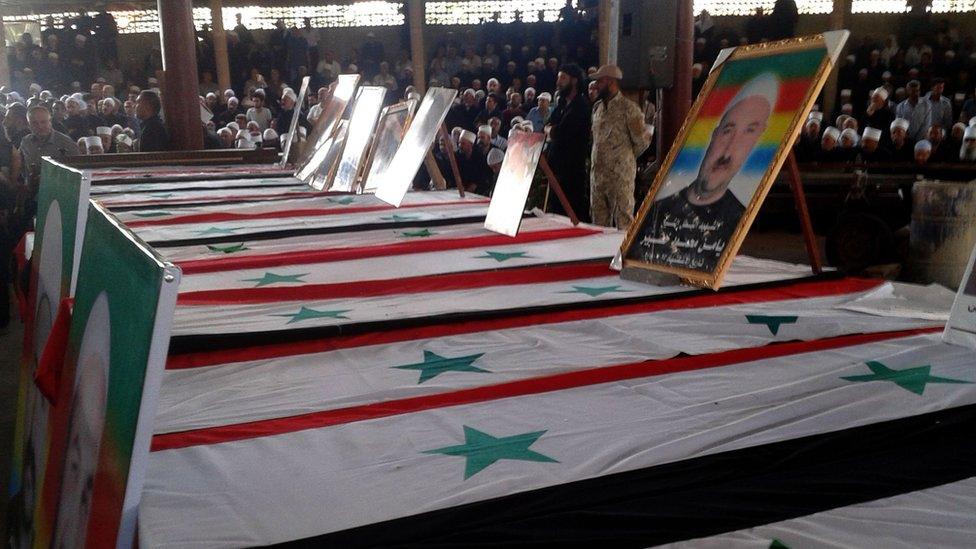 Coffins lined up at a mass funeral for the Druze victims of the IS attack on the southern city of Suweida on 26 July 2018