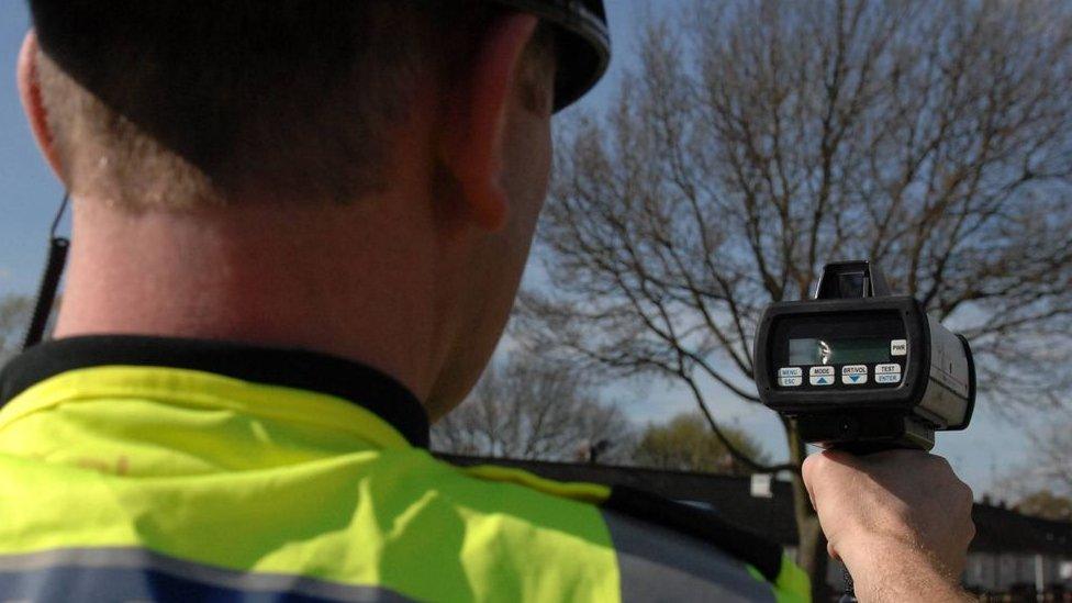 Person holding a speed camera