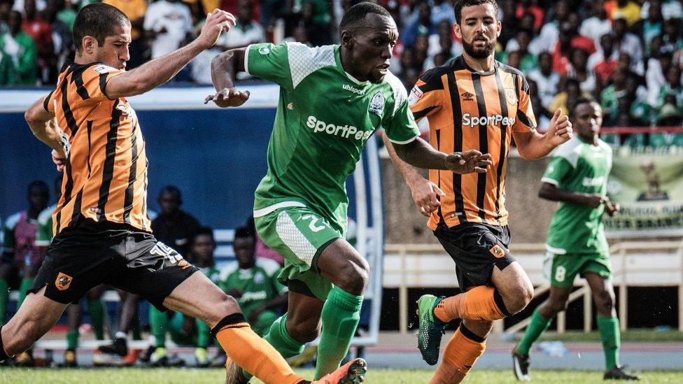 Meddie Kagere (C) of Kenyas Gor Mahia vies for the ball with Evandro Goebel (L) of Englands Hull city during their friendly match at the Kasarani stadium in Nairobi on May 13, 2018.