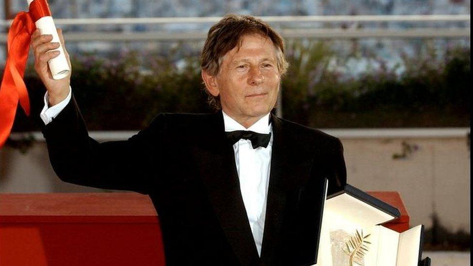 French director Roman Polanski poses with his Palme d'Or for the film The Pianist at the 55th Film Festival in Cannes, on the French Riviera, Sunday, May 26, 2002.