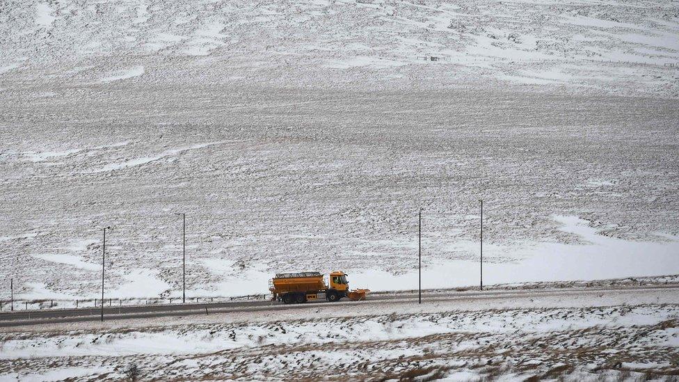 A gritting lorry clears snow on the A672 near the M62 motorway