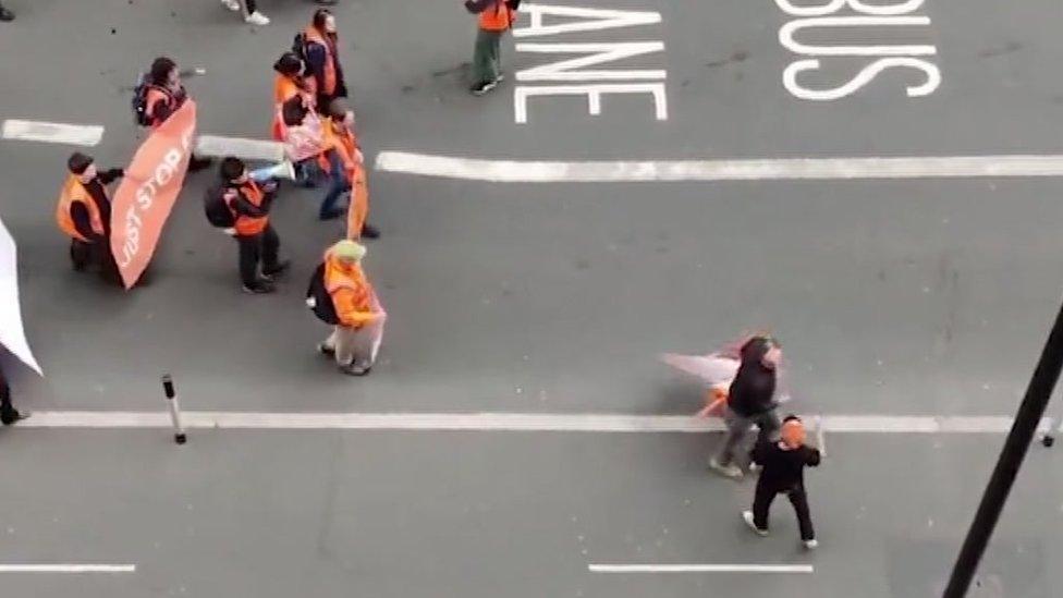 The man smacked a phone out of a protester's hands