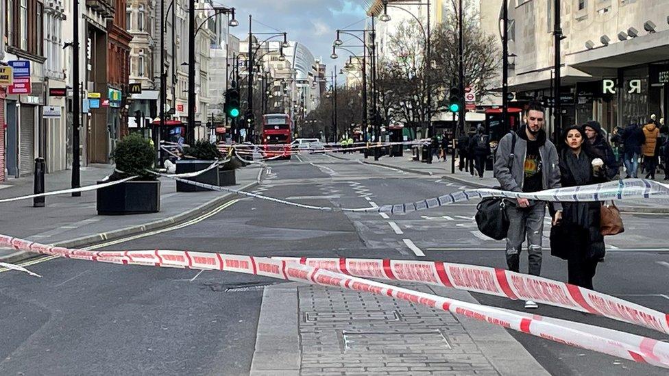 Image showing people walking past a police cordon across Oxford Street.