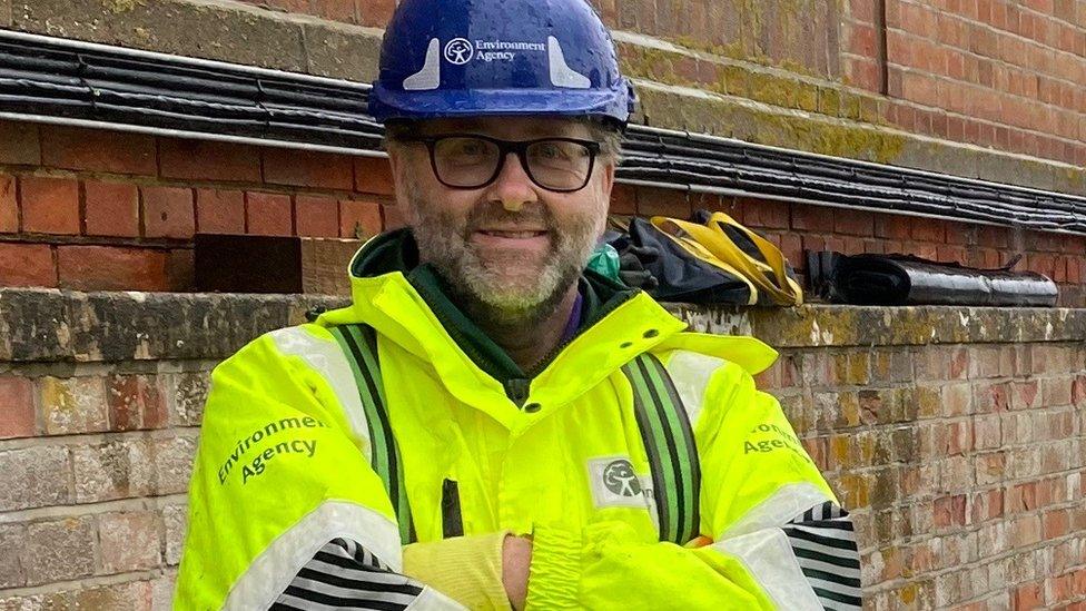 John Rowlands in his Environment Agency high vis jacket and safety helmet