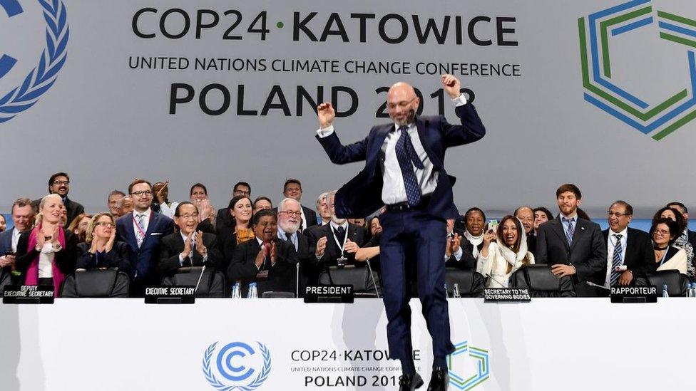 COP24 president Michal Kurtyka jumps at the end of the final session of the COP24 summit on climate change in Katowice, southern Poland, on December 15, 2018.