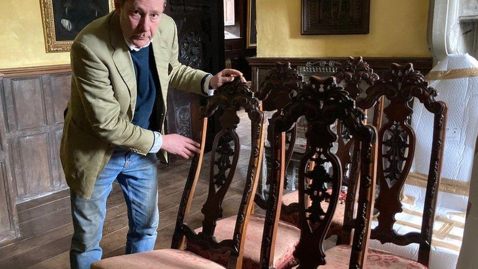 Peter Welford with some of the chairs (BBC)