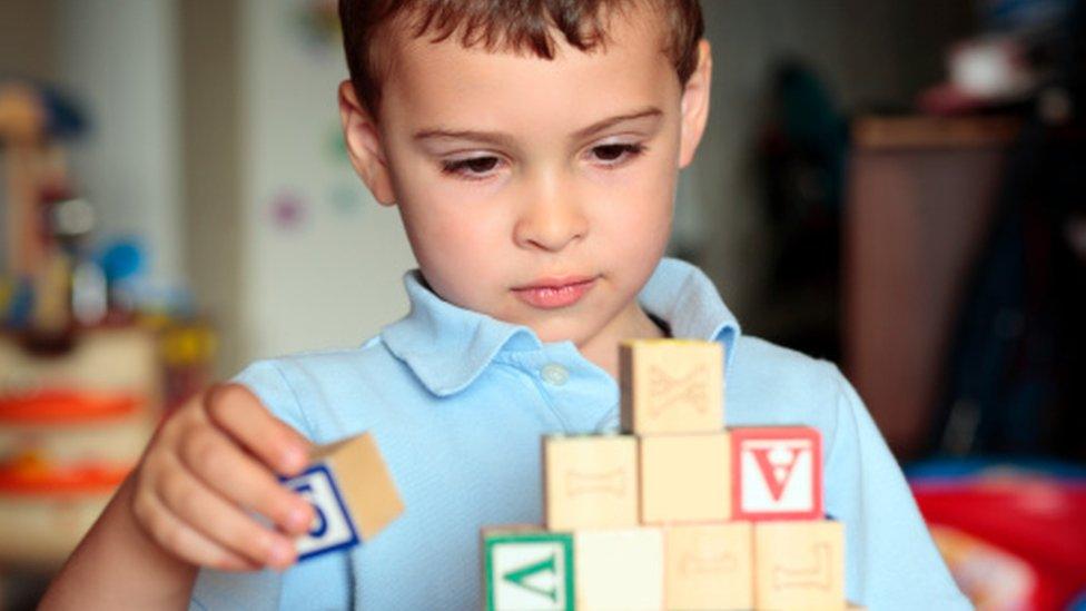 Boy with autism playing with bricks