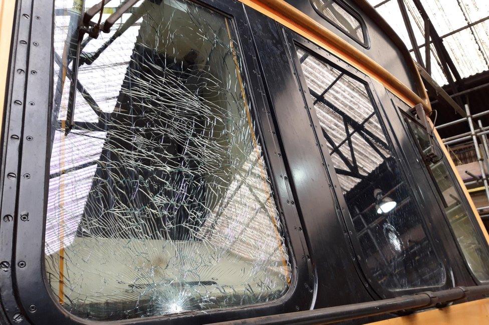 A smashed front window on a train