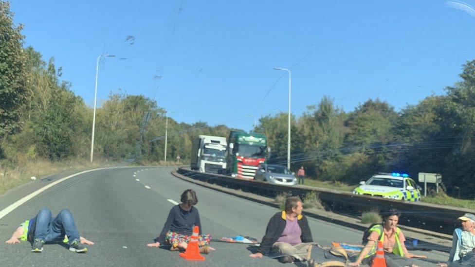 Protesters have glued themselves to the road