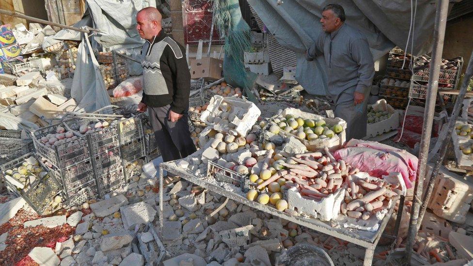 Aftermath of a reported air strike on a market in the rebel-held town of Atareb in northern Syria on 13 November 2017