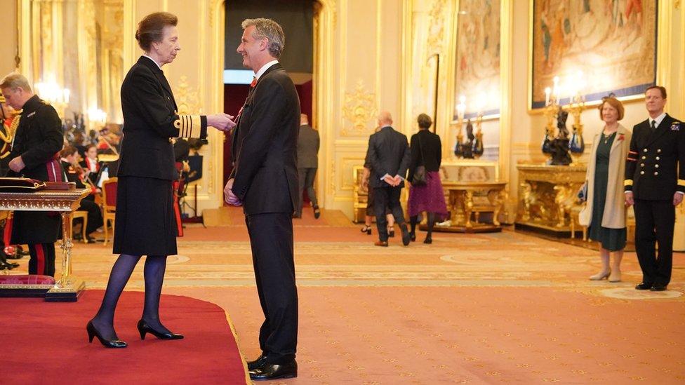 Presenter and Comedian Adam Hills is made a Member of the Order of the British Empire by the Princess Royal at Windsor Castle