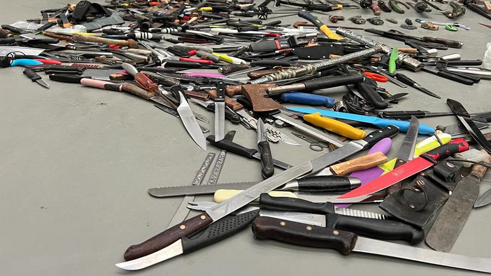 Pile of knives on floor