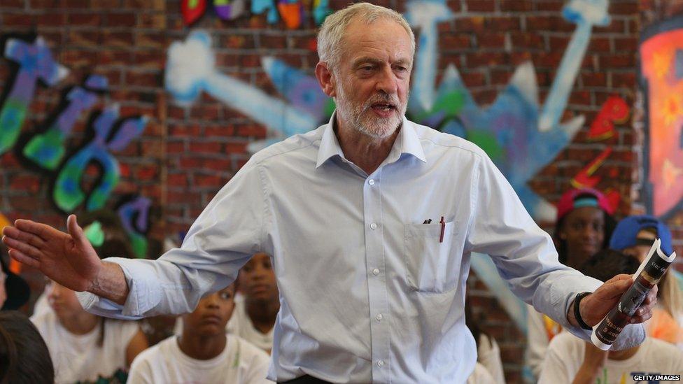 Labour leadership contender Jeremy Corbyn presents pupils with certificates after they perform in a play on their last day of school at Duncombe Primary School on July 16, 2015 in London, England.